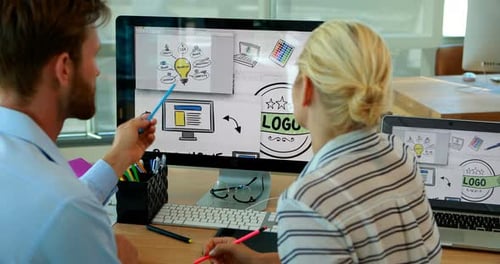 Designers Collaborate on Computer in Modern Office