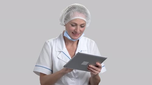Woman in Medical Coat Using Tablet Device
