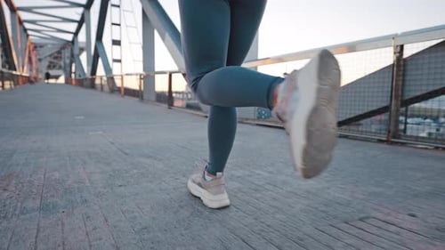 Trained Muscular Legs of Young Lady Jogger Running By Bridge