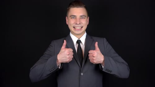 Young Adult Gives Two Thumbs Up in Studio