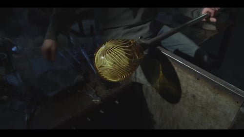 Glass Blower Shapes a Molten Sphere