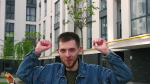 Young Man Dancing in Urban Courtyard, Expressing Joy