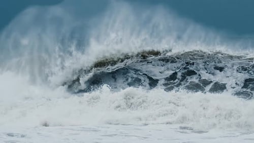 Big Wave with Foam and Dirt Breaks on the Shore During Strong Storm in the Atlantic Ocean