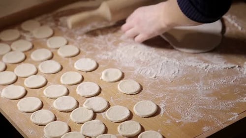 Rolling Dough With Rolling Pin On Wooden Surface