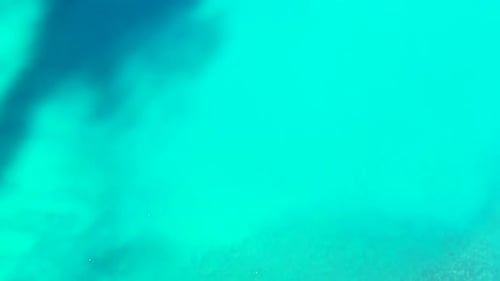 Aerial top down seascape of idyllic island beach voyage by aqua blue water and clean sandy backgroun