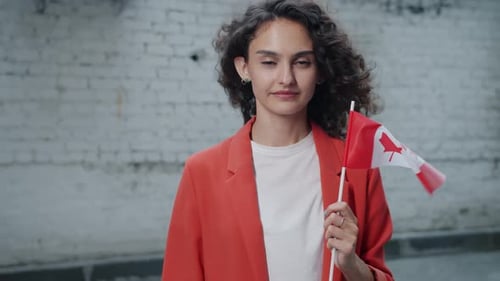 Young Woman Holds Canadian Flag Outdoors