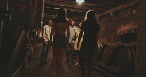 Friends Gather in a Rustic Wine Cellar