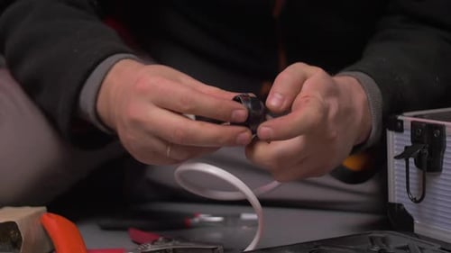 Man's Hands Connecting Electrical Wire in Close Up
