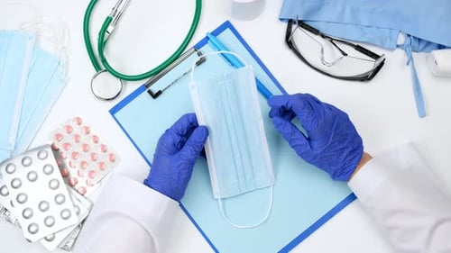 Medical Professional Prepares Protective Mask for Examination