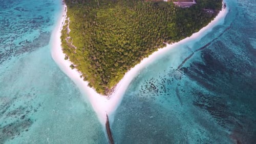 Top view of the Maldives island, where the city is located, surrounded by the incredible color of th