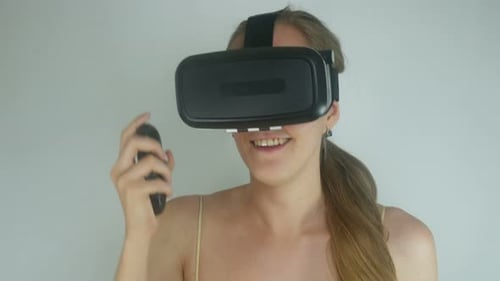 Blonde Woman Using Virtual Reality Headset and Controller