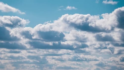 Dramatic White Clouds Moving Slowly in Blue Sky