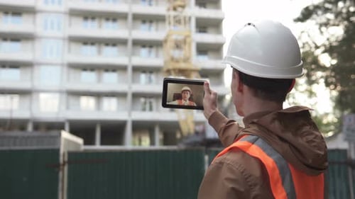 Construction Worker Video Calls From Building Site