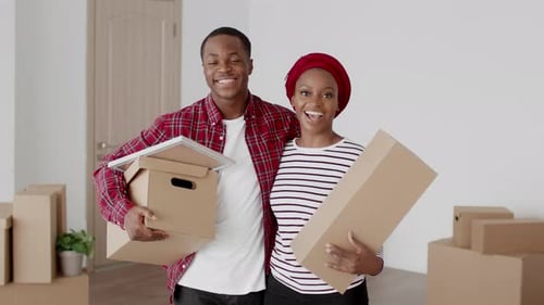 Happy Couple Moving Into New Home With Boxes