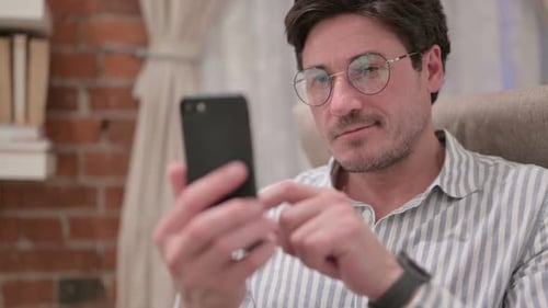 Man Using Smartphone Indoors Close Up