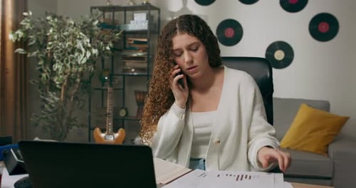 Busy Businesswoman Works From Home at Desk Fills Out Paperwork From Company Talks on the Phone with