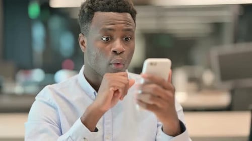 Man is Surprised and Celebrates Success on Phone