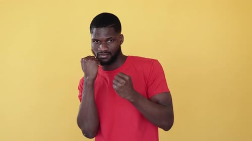 Man in Red Shirt with Fists Up Ready