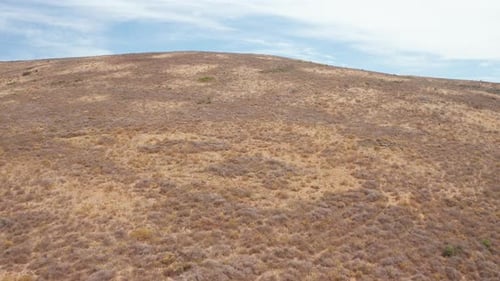 Flying Towards the Top of a Hill Revealing a Town in South Africa