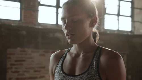 Workout. Woman doing high knees running in place exercise at gym