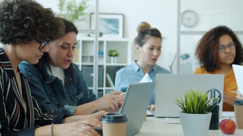Teamwork in Modern Office with Diverse Women