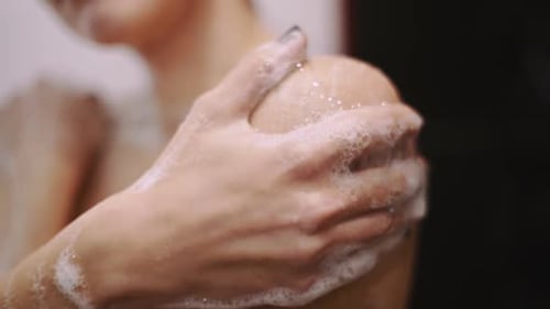 Beautiful Young Redhaired Woman Bathes in the Shower Washes Her Hair and Her Body