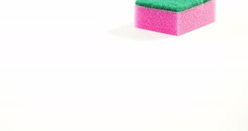 Vibrant Green and Pink Sponge on White Background