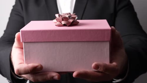 Man Holding Gift Box with Bow Close Up