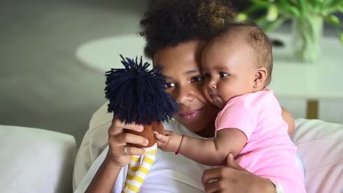 Young Adult and Baby with a Rag Doll