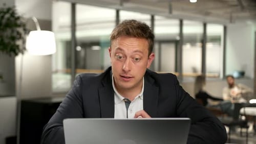 Male office worker communicates in zoom with work colleagues or clients
