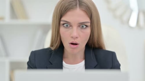 Close Up of Disappointed Businesswoman Reacting To Loss on Laptop