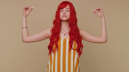 Serene Woman Meditating Indoors with Red Wavy Hair