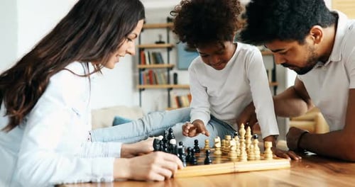 Happy Family Plays Chess in their Home