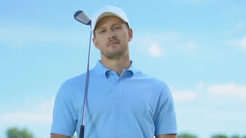 Handsome Golf Player Smiling Posing at Camera With Club, Training on Course
