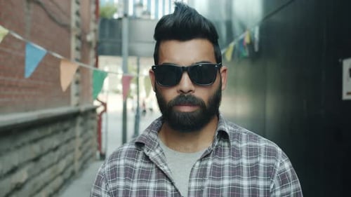 Bearded Man Wearing Sunglasses in City Alleyway
