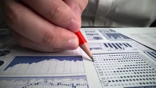 Accountant analyzing business marketing data on paper dashboard at office table.