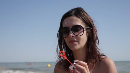 Soap bubbles blowing and enjoying ocean climate by female slow-mo 1920X1080 FullHD footage - Slow m