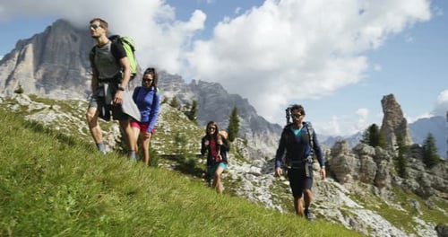 Four Friends Walking Along Wild Hiking Trail Path