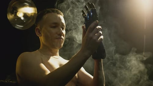 Man with Prosthetic Hand Adjusts the Device