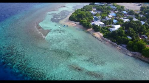 Aerial flying over panorama of idyllic island beach holiday by aqua blue water and white sand backgr