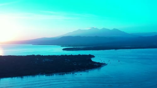 Glittering sunrise over tropical islands of Indonesia with sea surface reflecting sunlight around sh