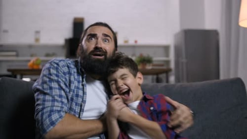 Father and Son Watching a Scary Movie