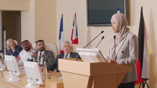 Woman Speaking at Podium During Conference