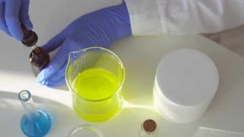 Dropping Liquid Into Beaker in a Lab