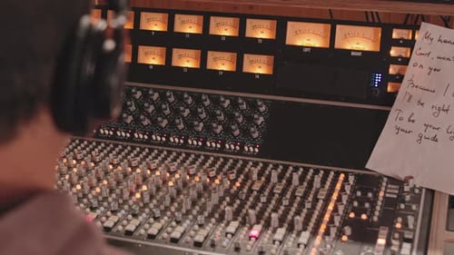 Music Producer Using Mixing Desk at Studio