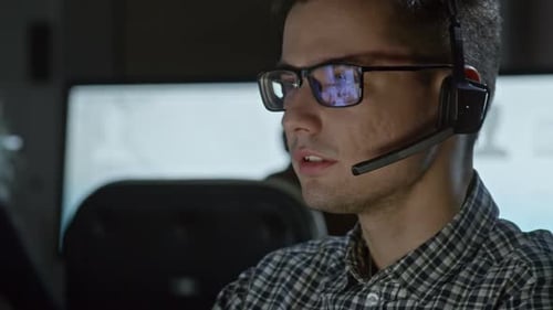 Male Call Centre Operator in Glasses Working