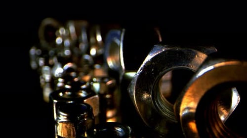 Close-Up of Metal Nuts and Bolts on Black
