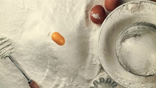 Super Slow Motion Egg Falls Into a Pile of Flour on the Table