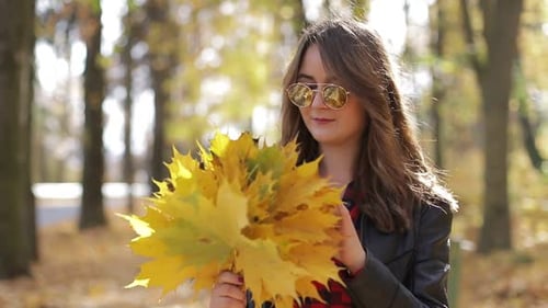 Beautiful teenage girl taking Selfie on smartphone outdoors in Park on Sunny autumn day