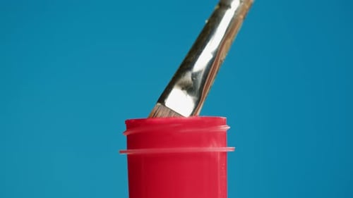 Red Paint Isolated on Blue Background